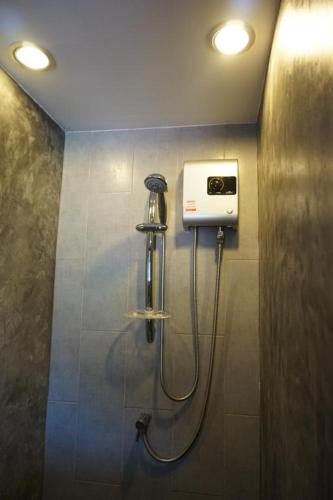 a shower in a bathroom with aperature at Replay Condo Studio Room in Bangrak Beach