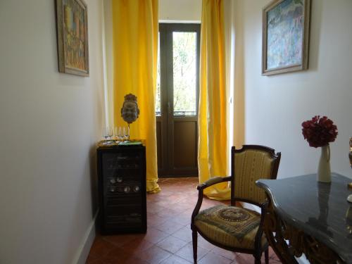 a dining room with yellow curtains and a table and chairs at La Grande Maison in Cambieure