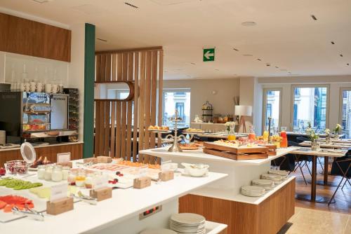 a kitchen with a counter with food on it at Lasala Plaza Hotel - Adults Only in Donostia-San Sebastián
