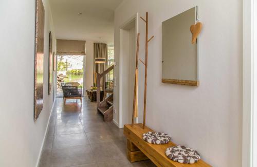 a hallway with a table and a mirror on a wall at Lotsenstieg 13b in Ostseebad Karlshagen