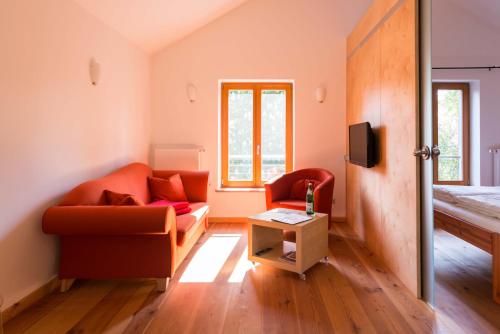 a living room with a couch and a table at Dreigärten Brodowin in Brodowin