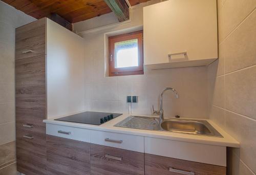 a kitchen with a sink and a window at Hotel Srakovcic Heart of Nature in Ribnik
