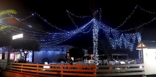 a string of blue lights hanging from a building at Hotel Beach in Tortoreto Lido