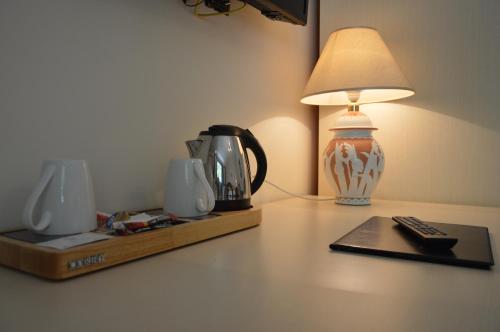 a table with a lamp and a remote control on it at Hotel Santa Lucia in Minori