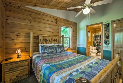 a bedroom with a bed and a wooden wall at Nantahala Cabins in Bryson City