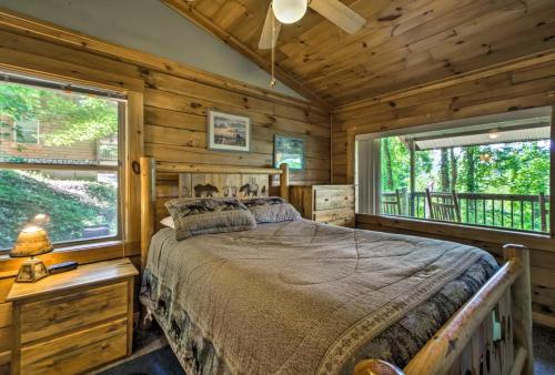 a bedroom with a bed in a log cabin at Nantahala Cabins in Bryson City