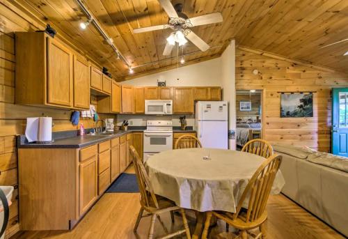 a kitchen and dining room with a table and chairs at Nantahala Cabins in Bryson City