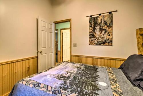 a bedroom with a bed and a painting on the wall at Nantahala Cabins in Bryson City