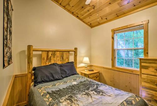 a bedroom with a bed and a window at Nantahala Cabins in Bryson City