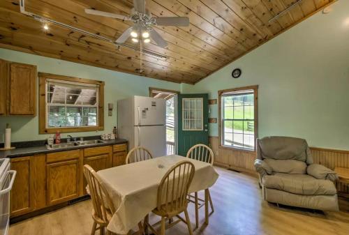 a kitchen and dining room with a table and chairs at Nantahala Cabins in Bryson City