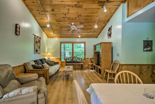 a living room with a couch and a ceiling fan at Nantahala Cabins in Bryson City