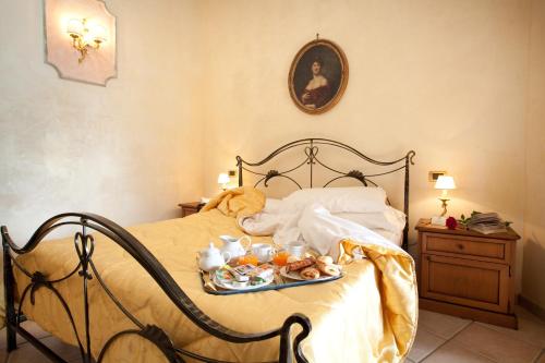 a bedroom with a bed with a tray of food on it at Hotel Villa Torre Antica in Atena Lucana