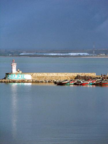 a lighthouse on an island in a body of water at Maison d'hôtes Cité Portugaise in El Jadida