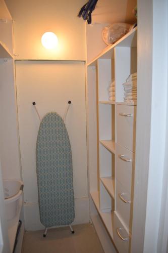 a room with a closet with a surfboard in it at Golden View Apartment in Saint James