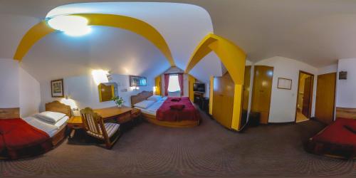 a large room with two beds and a room with at Hotel Garten in Slavonski Brod