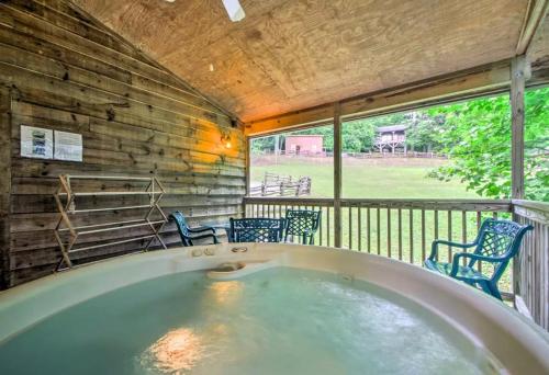 a jacuzzi tub on a screened in porch at Nantahala Cabins in Bryson City