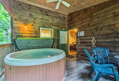 a jacuzzi tub on the deck of a cabin at Nantahala Cabins in Bryson City