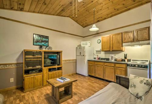a kitchen with wooden cabinets and a white refrigerator at Nantahala Cabins in Bryson City