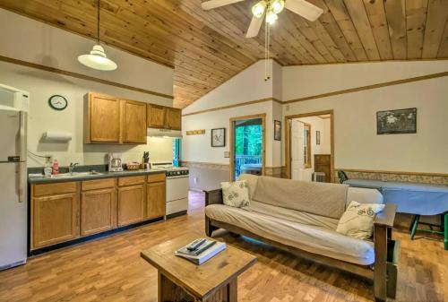 a living room with a couch and a kitchen at Nantahala Cabins in Bryson City