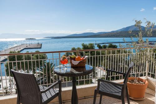 a table with a bowl of fruit on a balcony at Galini Hotel in Itea