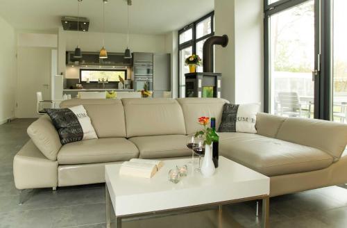 a living room with a couch and a table at Kapitaensweg 28 in Ostseebad Karlshagen