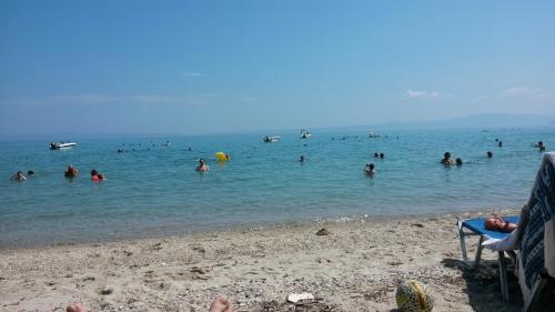 a group of people in the water at a beach at Polichrono in Polykhrono
