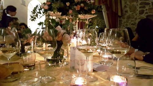 a table with wine glasses and flowers and candles at Hotel Villa Torre Antica in Atena Lucana