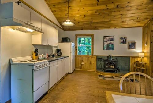 a kitchen with white appliances and a stove top oven at Nantahala Cabins in Bryson City