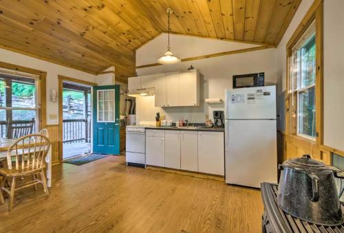 a kitchen with a white refrigerator and a table at Nantahala Cabins in Bryson City