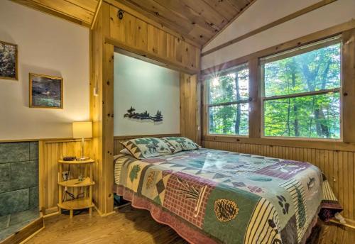 a bedroom with a bed and a window at Nantahala Cabins in Bryson City