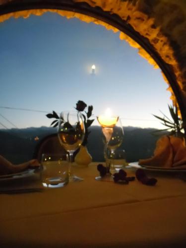 a table with wine glasses and a candle on it at Hotel Villa Torre Antica in Atena Lucana