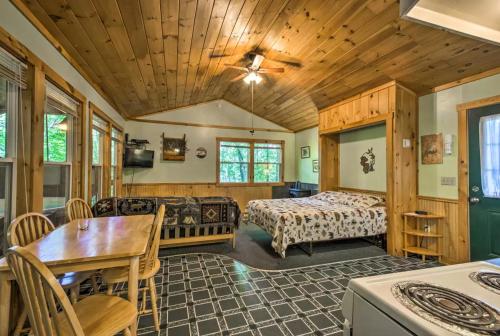 a bedroom with a bed and a table and chairs at Nantahala Cabins in Bryson City