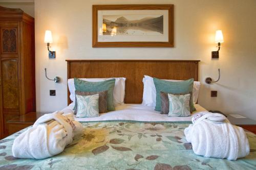 a bedroom with a large bed with towels on it at Armathwaite Hall Hotel & Spa in Bassenthwaite