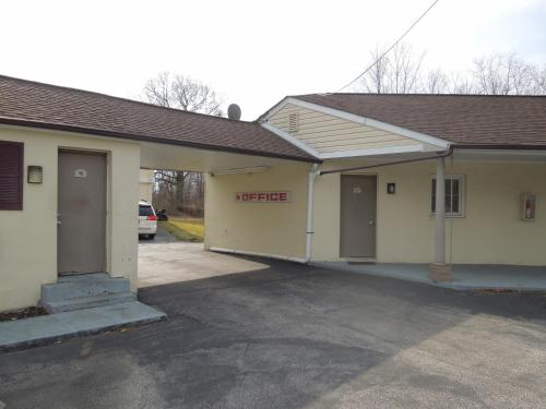 a building with two garage doors in a parking lot at Red Lion Motel Southampton in Southampton