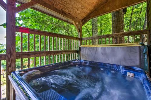a hot tub on the deck of a tree house at Nantahala Cabins in Bryson City
