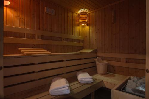 a sauna with two white towels sitting in it at Boutique Hotel Uniqato in Bansko