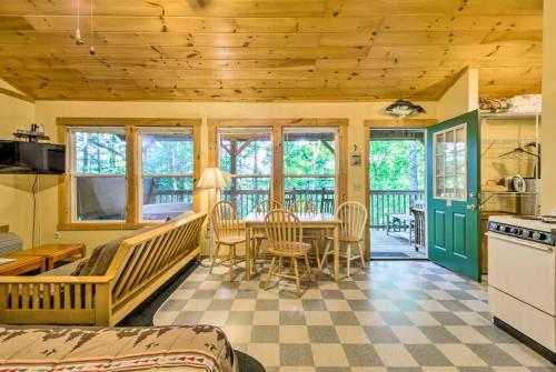 a kitchen and dining room with a table and chairs at Nantahala Cabins in Bryson City