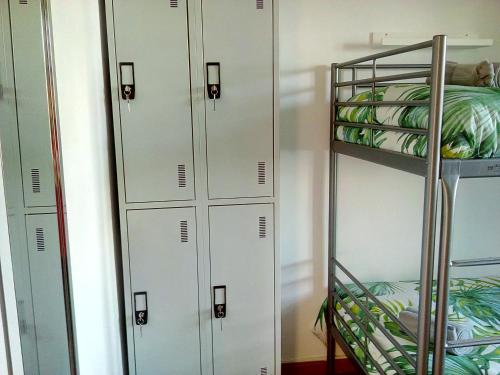 a row of lockers in a locker room at Fonte da Telha Beach Hostel in Costa da Caparica