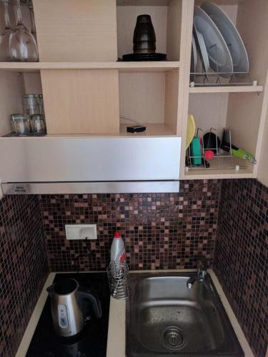 a kitchen counter with a sink in a kitchen at APARTMENTS by the SEA in Leptokarya