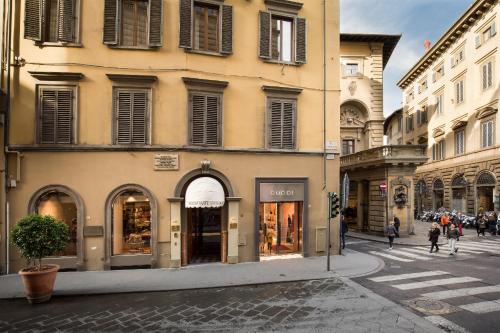 a building on a street with people walking on the street at Room Mate Collection Isabella, Florence in Florence