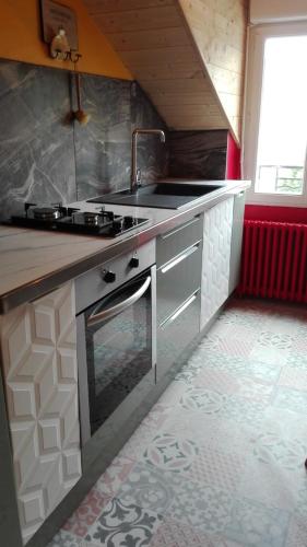 a kitchen with a sink and a stove at Villa Étienne in Le Mont-Dore