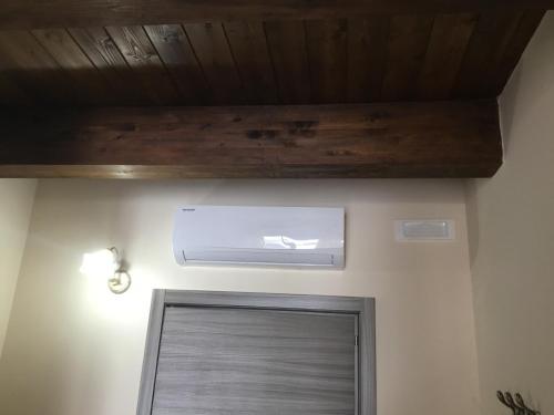 a room with a door and a wooden ceiling at B&B Nonna Maria in Lamezia Terme
