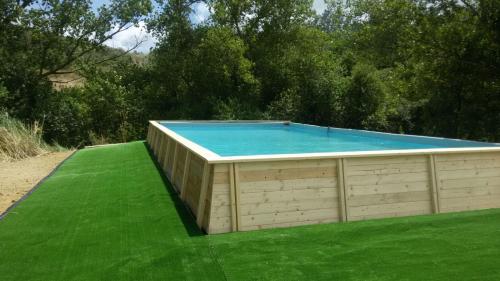 a swimming pool in a building on a green lawn at Il Bevaio Di Corleone in Corleone