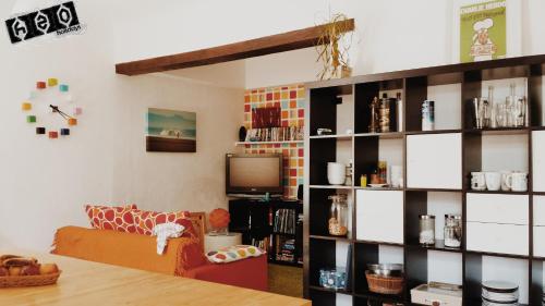 a living room with a couch and a book shelf at h2oholidays for you in Capbreton