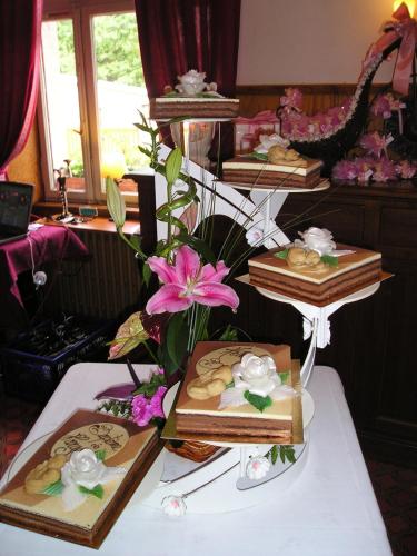 a table topped with boxes of cookies and flowers at Logis Hôtel Restaurant La Tête Des Faux in Le Bonhomme