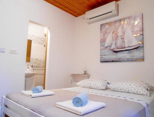 a bedroom with a bed with towels on it at Accommodation Susović in Lastovo
