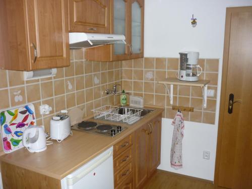 a kitchen with a sink and a stove top oven at Apartman Hrabice in Vimperk