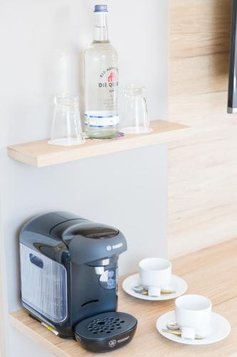 a bottle of water and a coffee maker on a shelf at Brüngers Landhaus in Rödinghausen