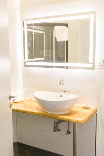 a bathroom with a white sink and a mirror at Brüngers Landhaus in Rödinghausen