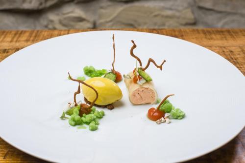 a white plate with food on a table at Romantik Hotel Chalet am Kiental in Herrsching am Ammersee